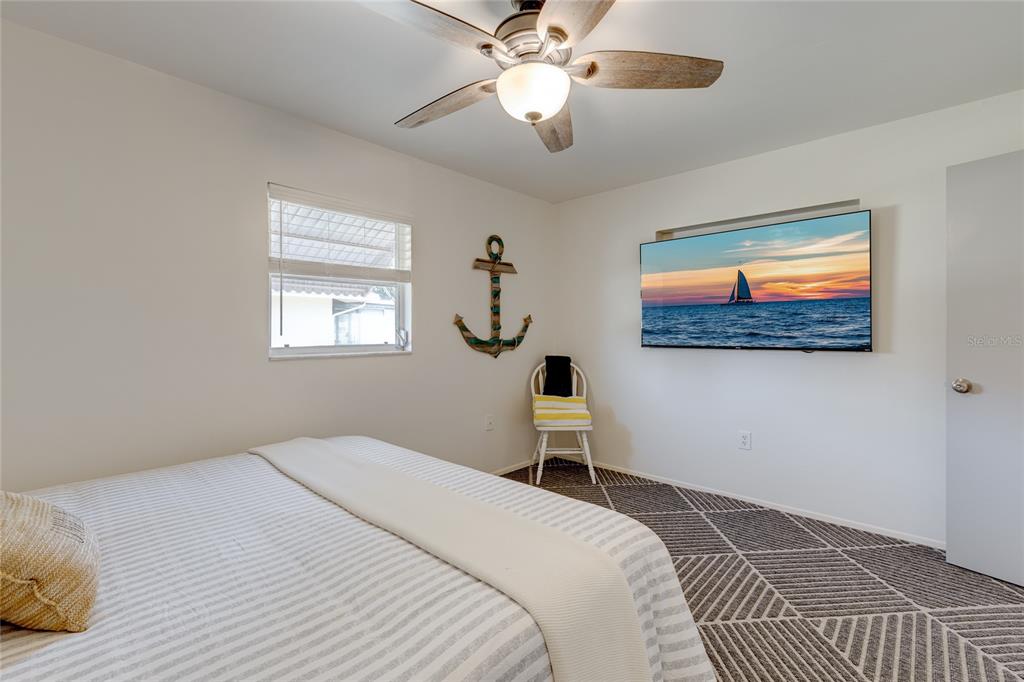 231 Caddy Road Rotonda West, FL 33947 - Photo 19 of 24 a bedroom with a bed and a chandelier
