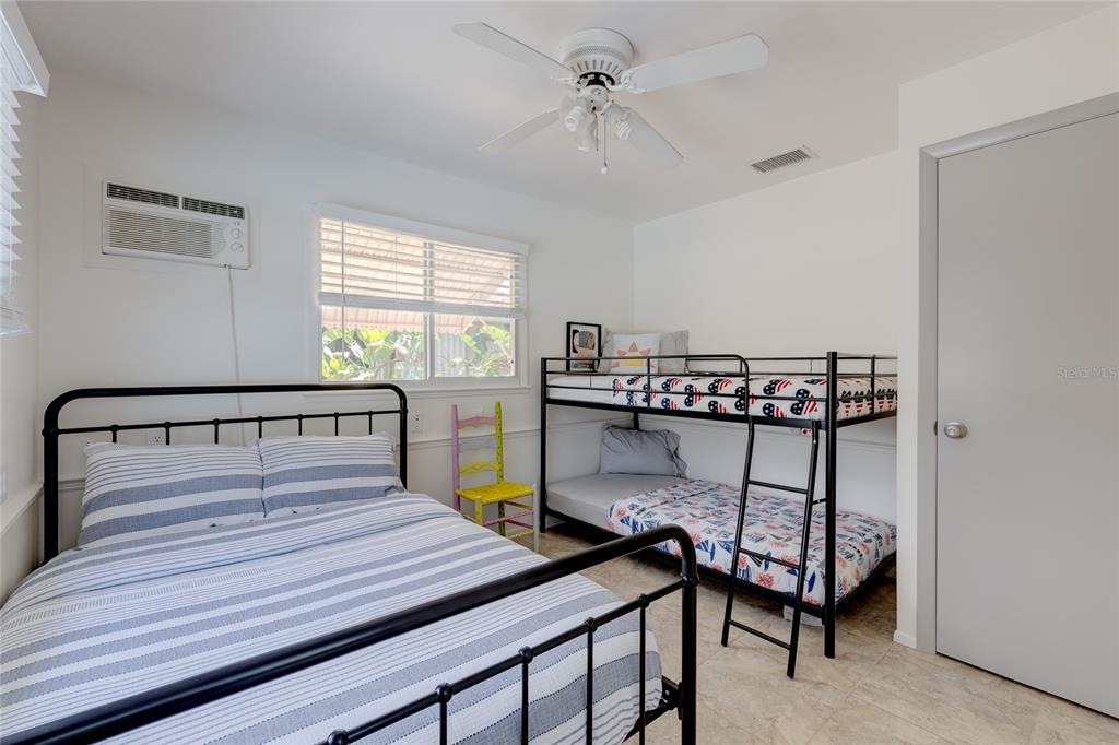 231 Caddy Road Rotonda West, FL 33947 - Photo 20 of 24 a bedroom with a bed a table and chair