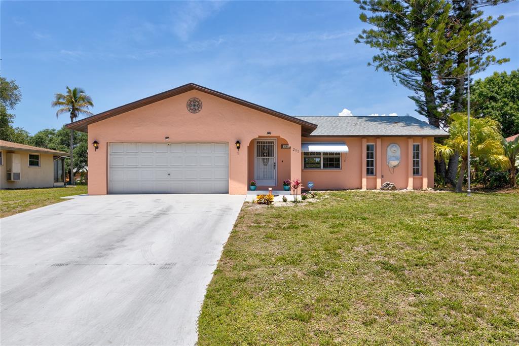 231 Caddy Road Rotonda West, FL 33947 - Photo 24 of 24 a view of a house with a yard and potted plants