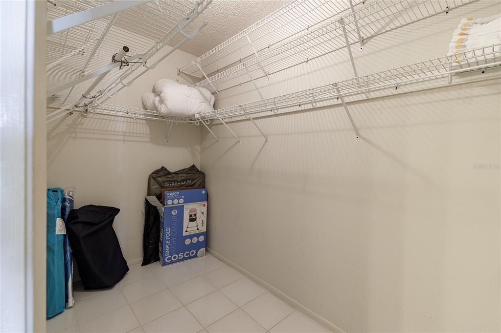 231 Caddy Road Rotonda West, FL 33947 - Photo 9 of 24 a view of a closet area with racks on the wall