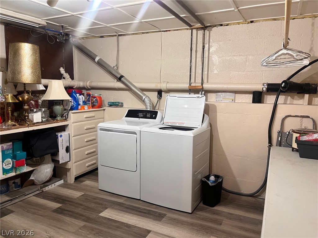 12 Reno Road Ely, NV 89301 - Photo 13 of 21 Laundry room with dark wood-style flooring, washer and dryer, and concrete block wall