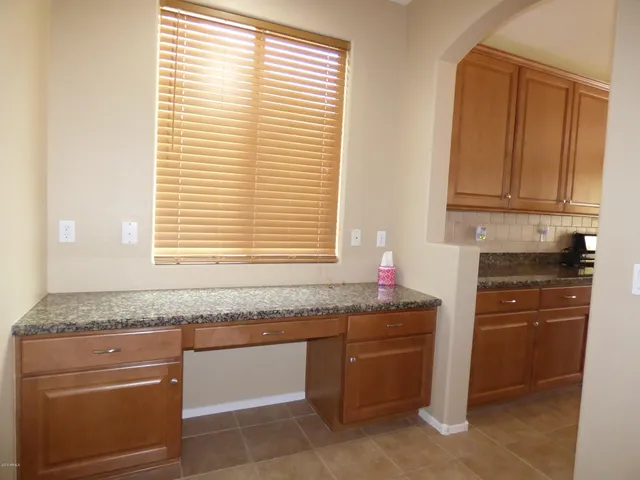 a view of empty room with windows and ceiling fan
