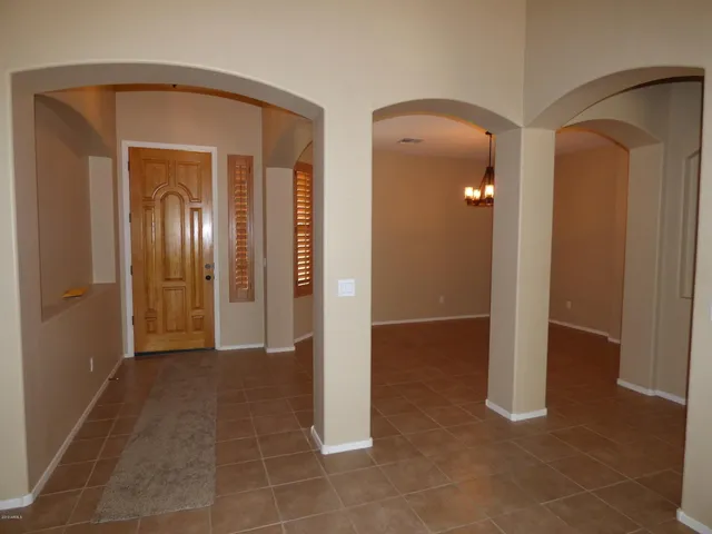 a view of an empty room with a window and fireplace