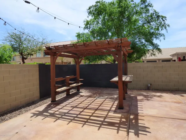a view of a house with backyard and sitting area