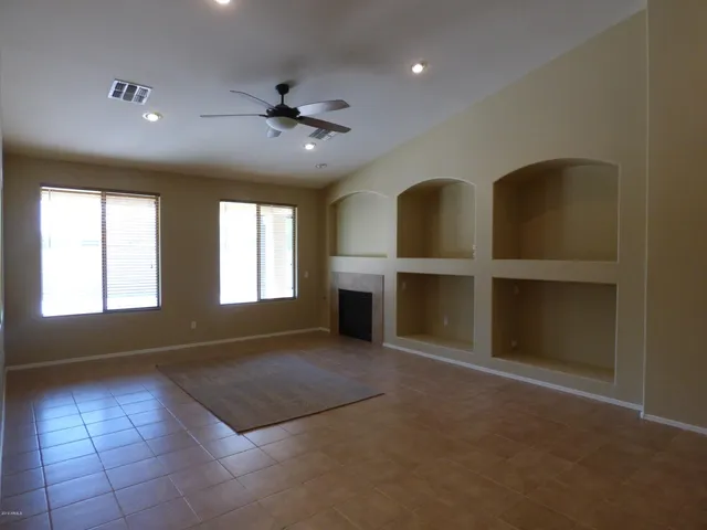 a view of a livingroom with a ceiling fan and window