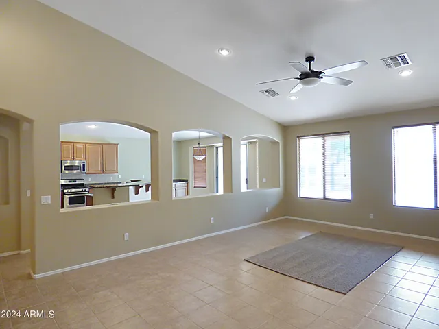 a kitchen with granite countertop cabinets sink and window