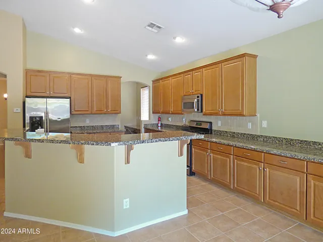a kitchen with refrigerator and stove