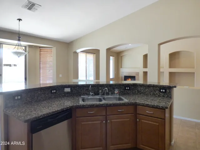 a kitchen with stainless steel appliances granite countertop a refrigerator a stove a sink a microwave a counter top and cabinets