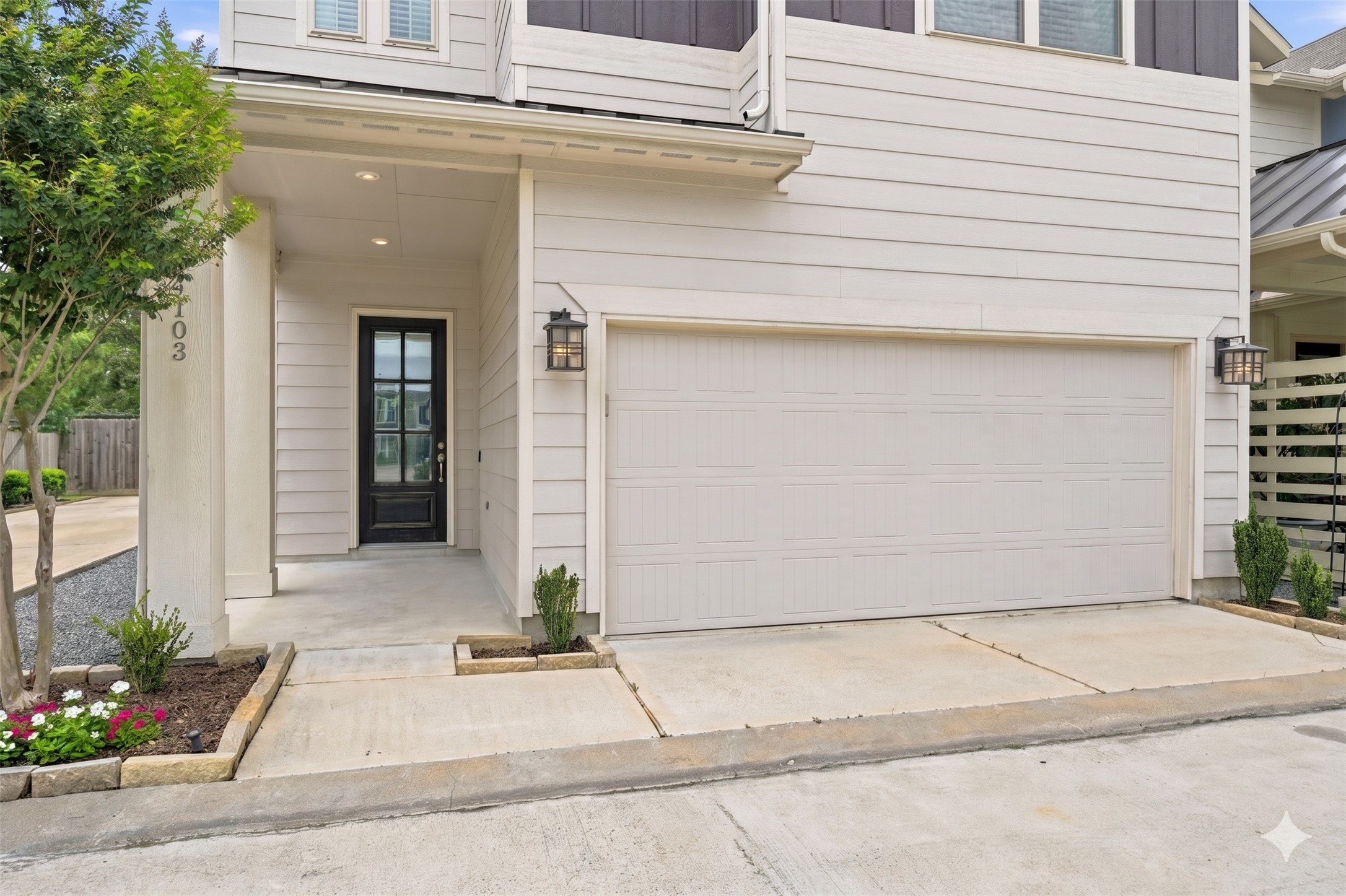 4103 Tranquil Square Road Houston, TX 77043 - Photo 2 of 39 A picturesque covered front porch with an 8ft. 6 paned glass door is complemented by traditional coach lanterns at the garage, setting the tone for this home's inviting character. Additional parking is available in the community as well.