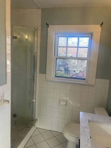 a bathroom with a toilet and a shower