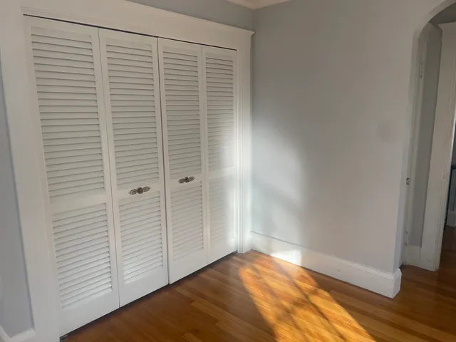 an empty room with wooden floor