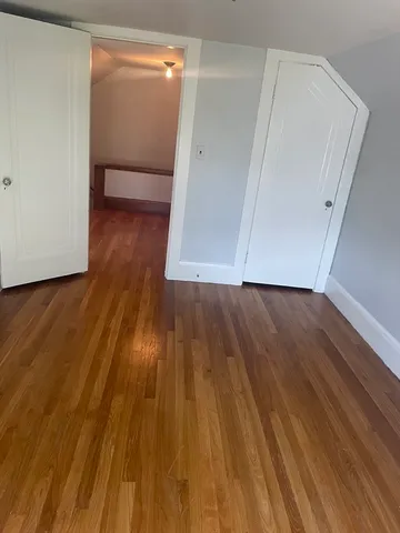 a view of hallway with wooden floor