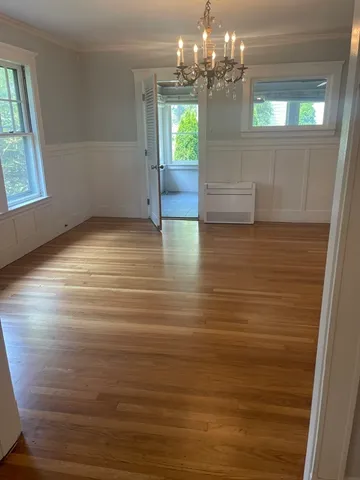 a view of a room with window and chandelier