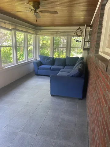 a living room with a couch and a large window