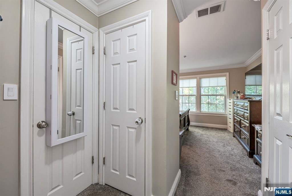 1034 Castle Road Mahwah, NJ 07430 - Photo 12 of 21 a view of a hallway with wooden shelves