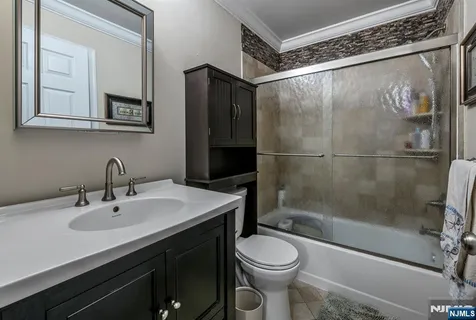 a bathroom with a sink mirror vanity and toilet