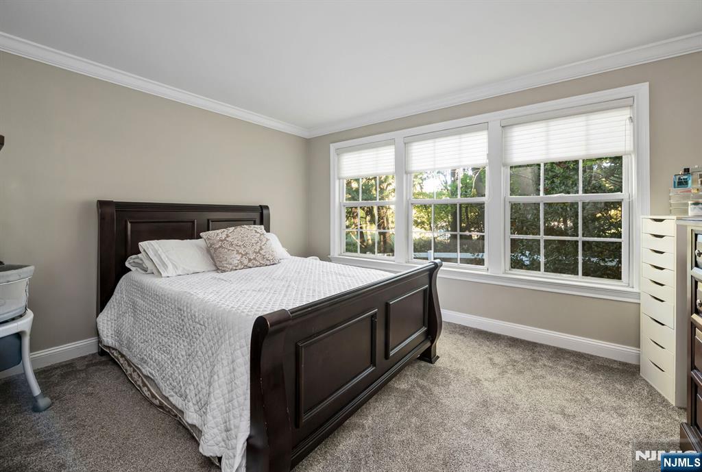1034 Castle Road Mahwah, NJ 07430 - Photo 14 of 21 a spacious bedroom with a bed and a large window