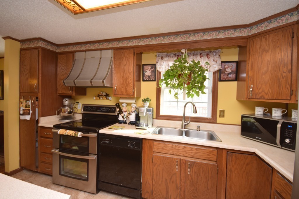 35 Driftwood Road Springfield, MA 01128 - Photo 4 of 26 a kitchen with a sink a stove and a refrigerator