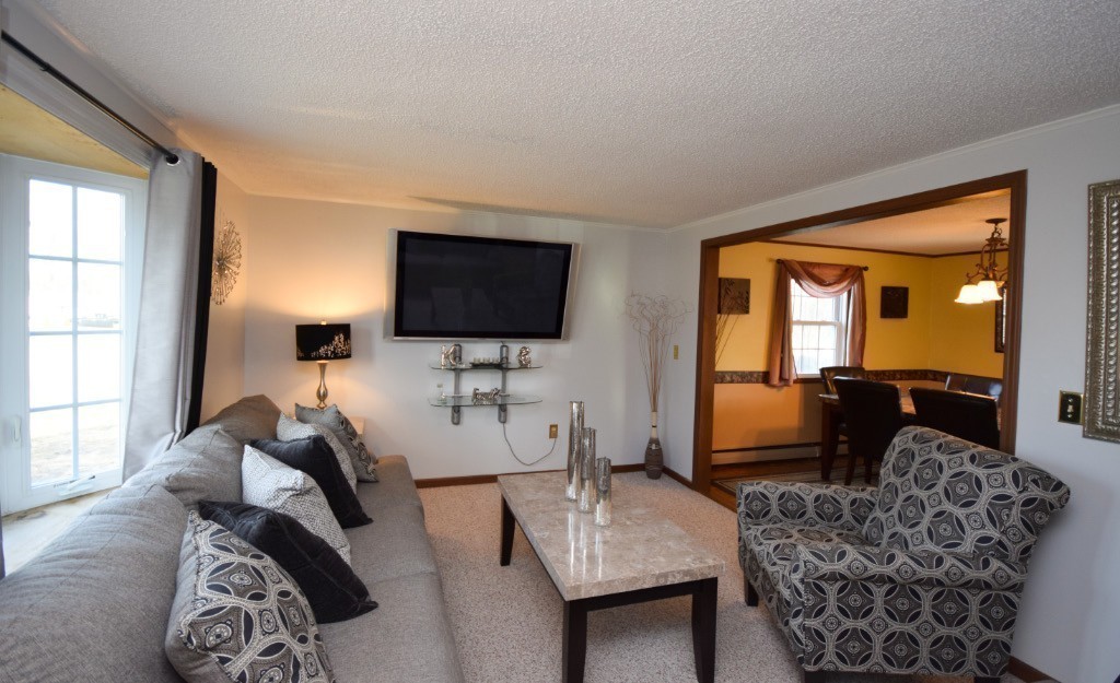 35 Driftwood Road Springfield, MA 01128 - Photo 8 of 26 a living room with furniture a flat screen tv and a window