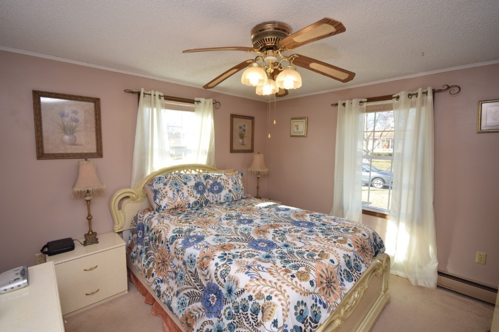 35 Driftwood Road Springfield, MA 01128 - Photo 10 of 26 a bedroom with a bed and a chandelier