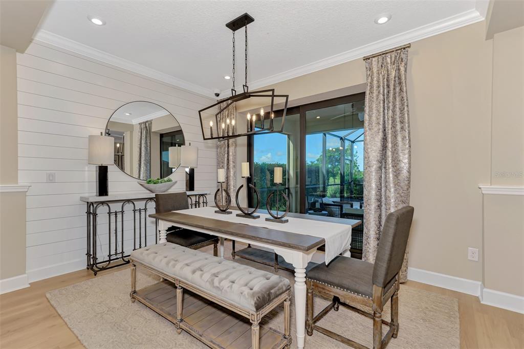 8216 Summer Night Road Sarasota, FL 34241 - Photo 11 of 60 a view of a dining room with furniture window and wooden floor