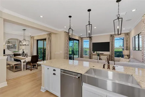 a living room with furniture a flat screen tv and a floor to ceiling window