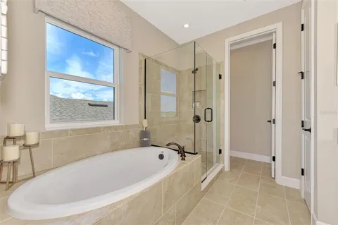 a large bed sitting in a bedroom next to a window