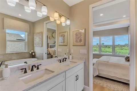 a bedroom with a bed and dresser with mirror