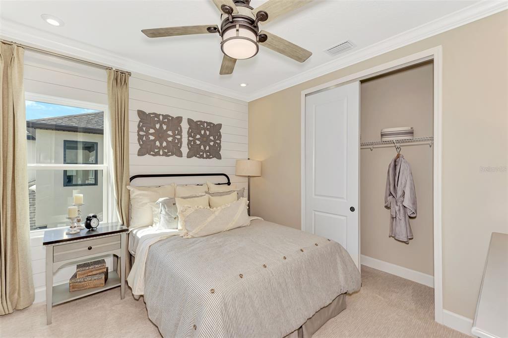 8216 Summer Night Road Sarasota, FL 34241 - Photo 47 of 60 a bedroom with a bed and a chandelier