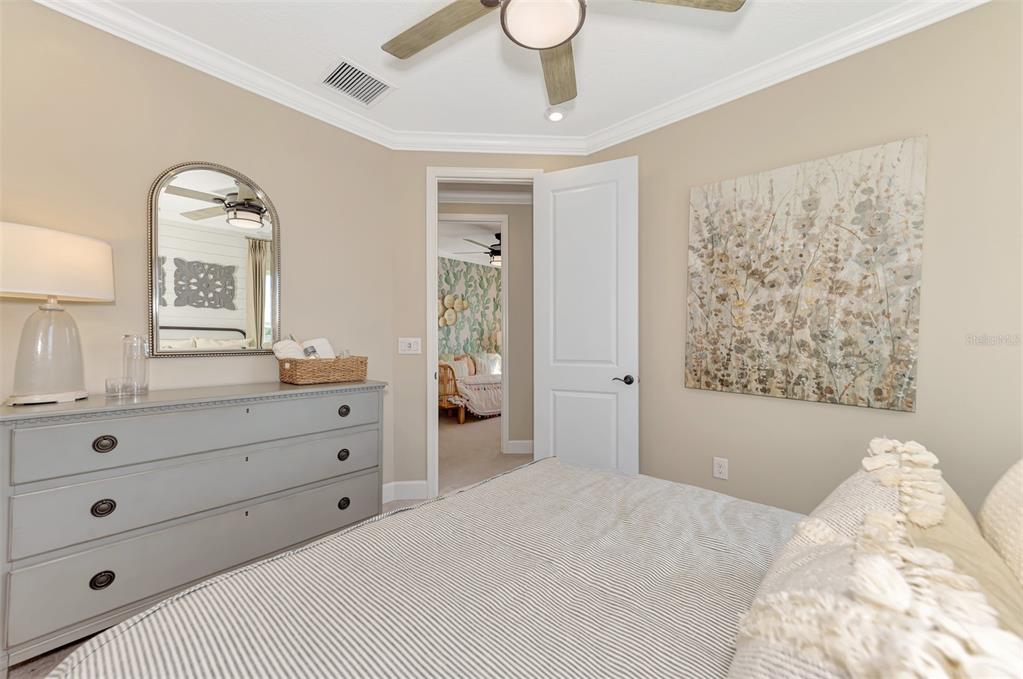 8216 Summer Night Road Sarasota, FL 34241 - Photo 48 of 60 a bedroom with a bed and a dresser