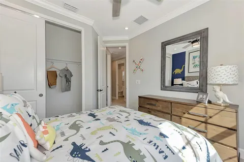 a sign that is sitting in front of a house with a big yard