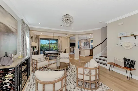 a living room with furniture a table and kitchen view