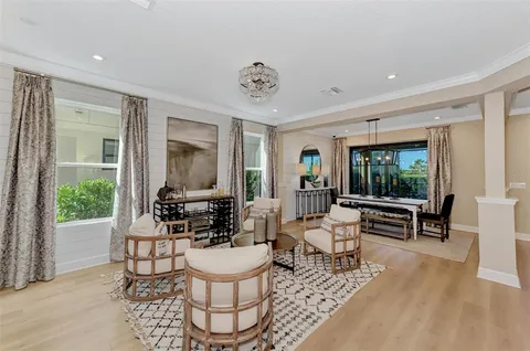 a living room with furniture a window and kitchen view