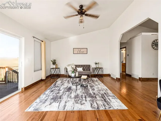 a living room with couch and wooden floor