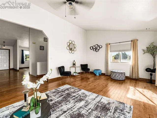 a living room with furniture and wooden floor