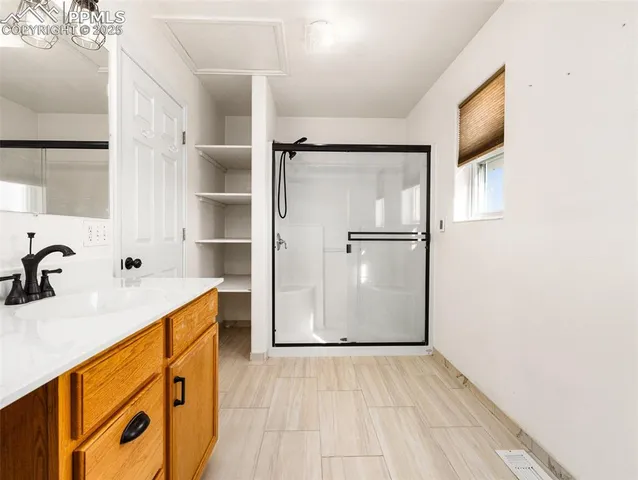 a view of a kitchen with a sink and a refrigerator