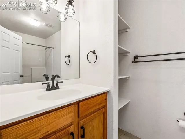a bathroom with a sink and cabinets