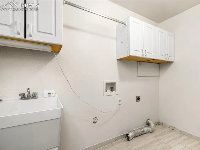 a view of a house with a wooden fence