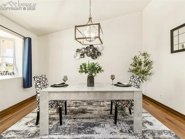 a view of a dining room with furniture and a potted plant