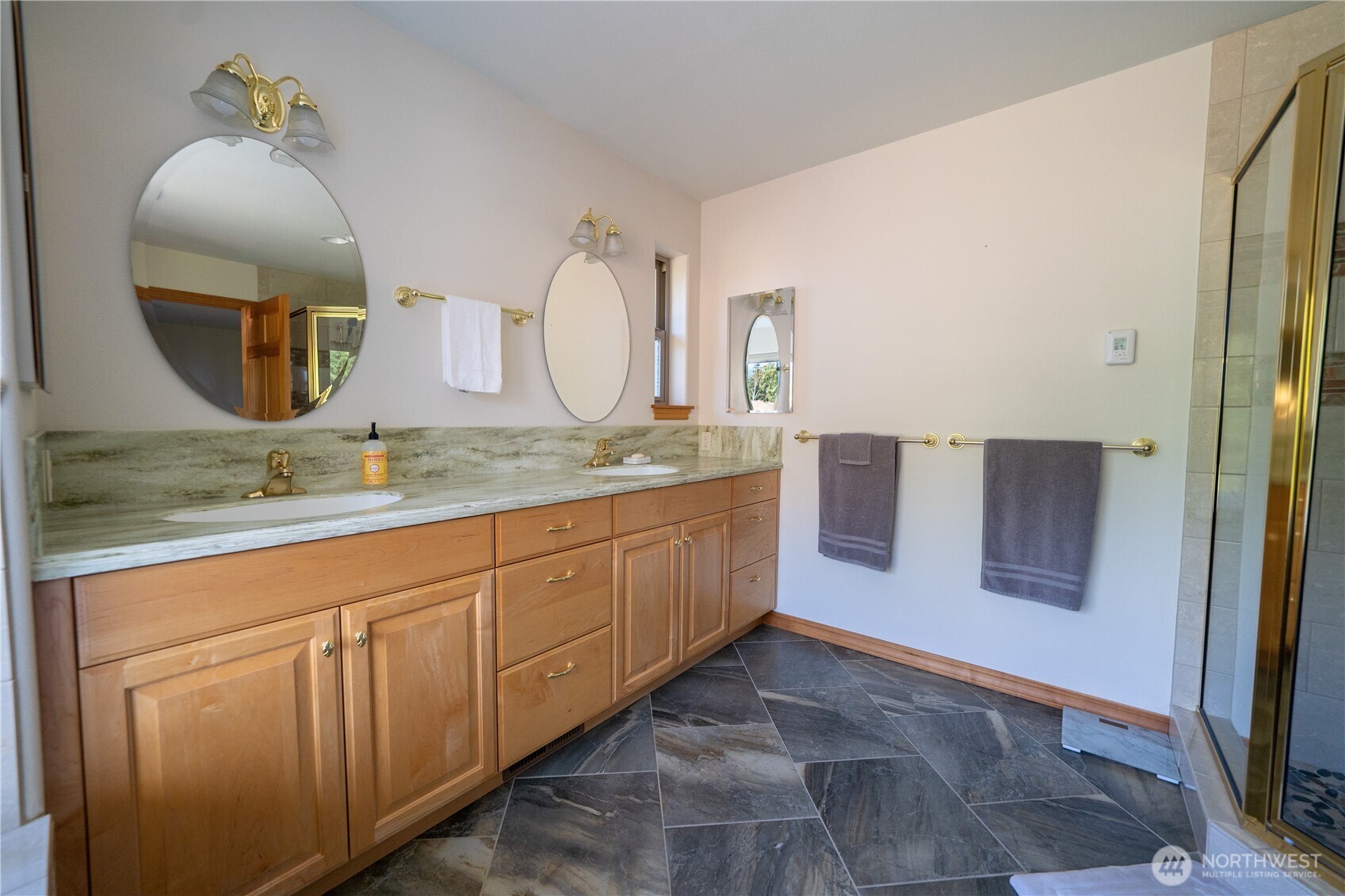 212 Maletti Hill Road Port Angeles, WA 98362 - Photo 24 of 37 a spacious bathroom with a granite countertop sink and a mirror