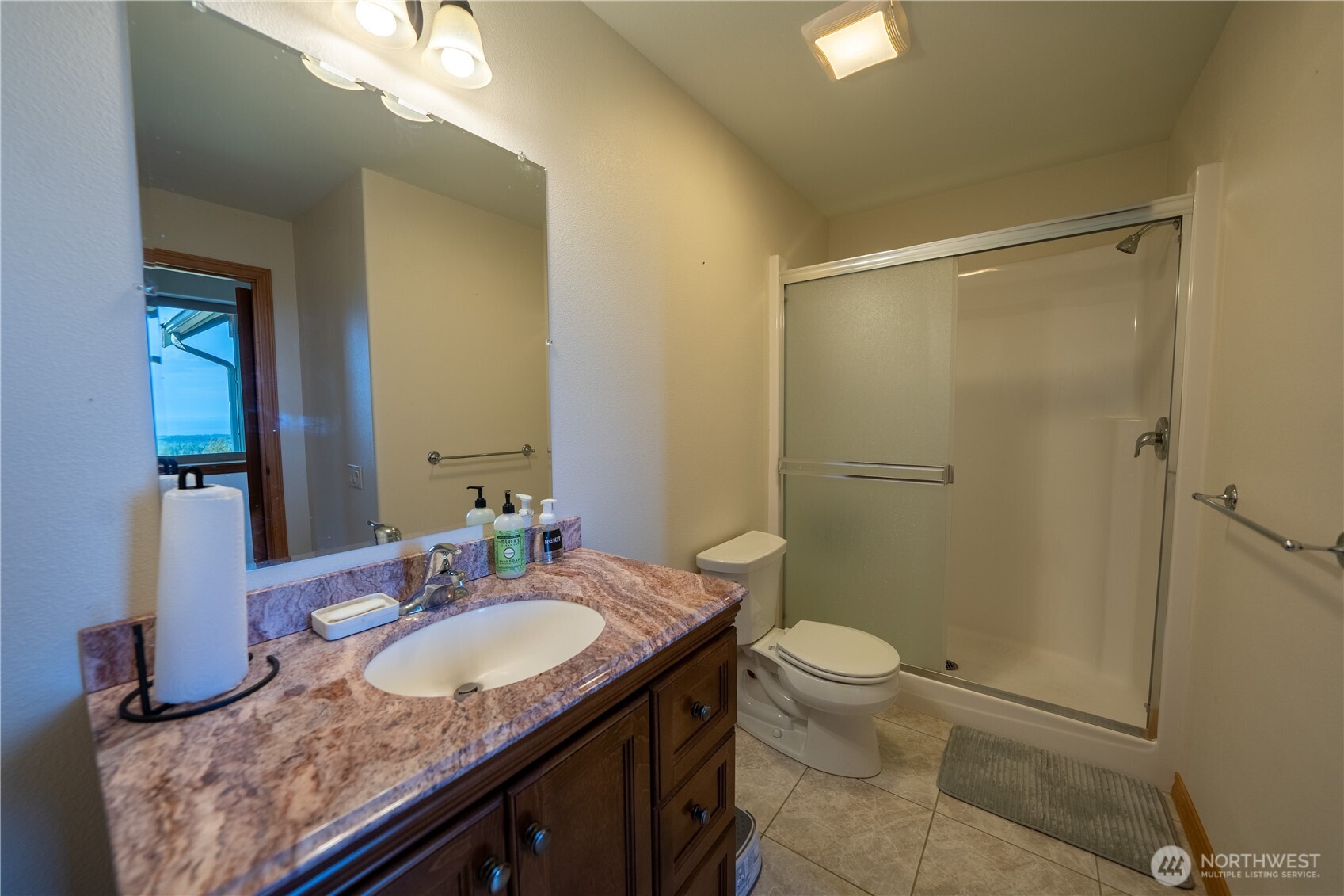 212 Maletti Hill Road Port Angeles, WA 98362 - Photo 26 of 37 a bathroom with a granite countertop sink toilet and shower