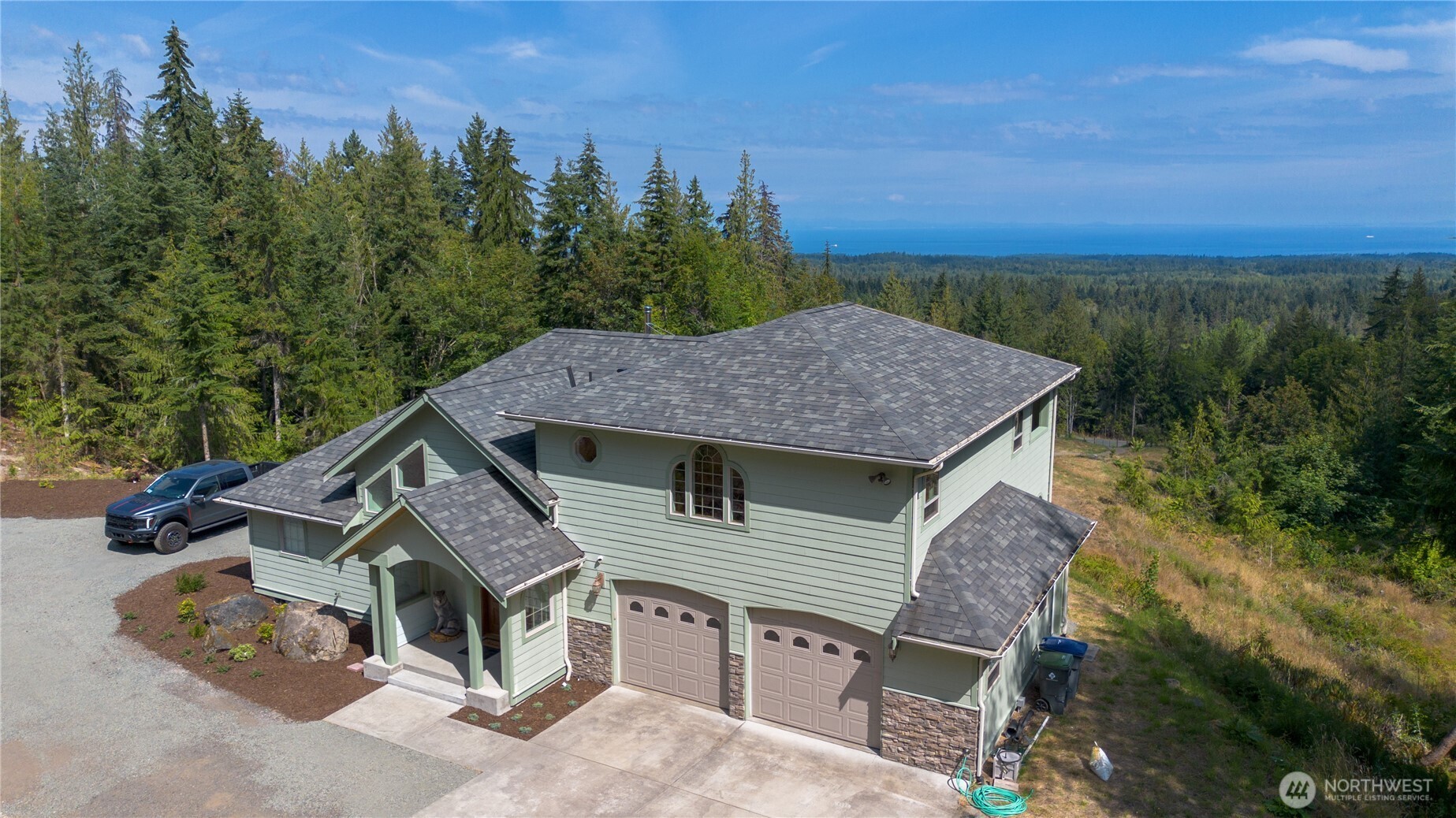 212 Maletti Hill Road Port Angeles, WA 98362 - Photo 27 of 37 a aerial view of a house with a yard and balcony