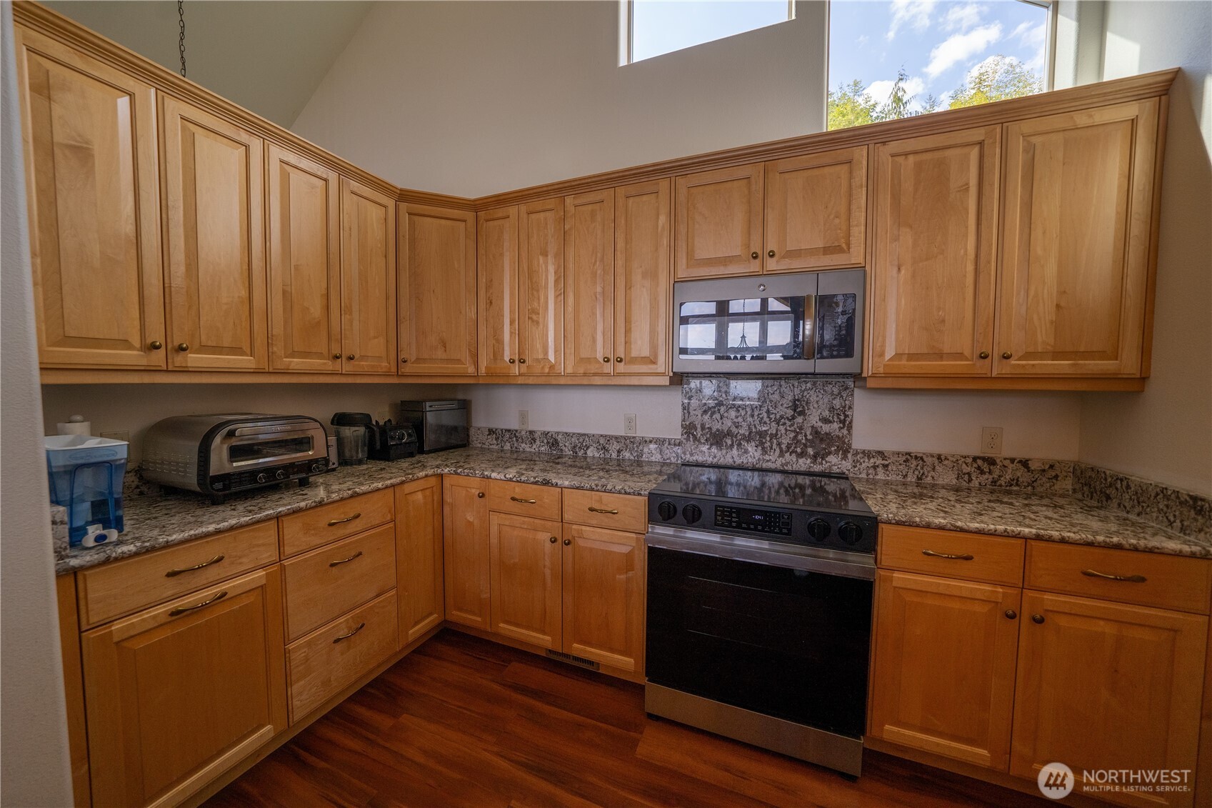 212 Maletti Hill Road Port Angeles, WA 98362 - Photo 8 of 37 a kitchen with stainless steel appliances granite countertop wooden cabinets and a stove top oven