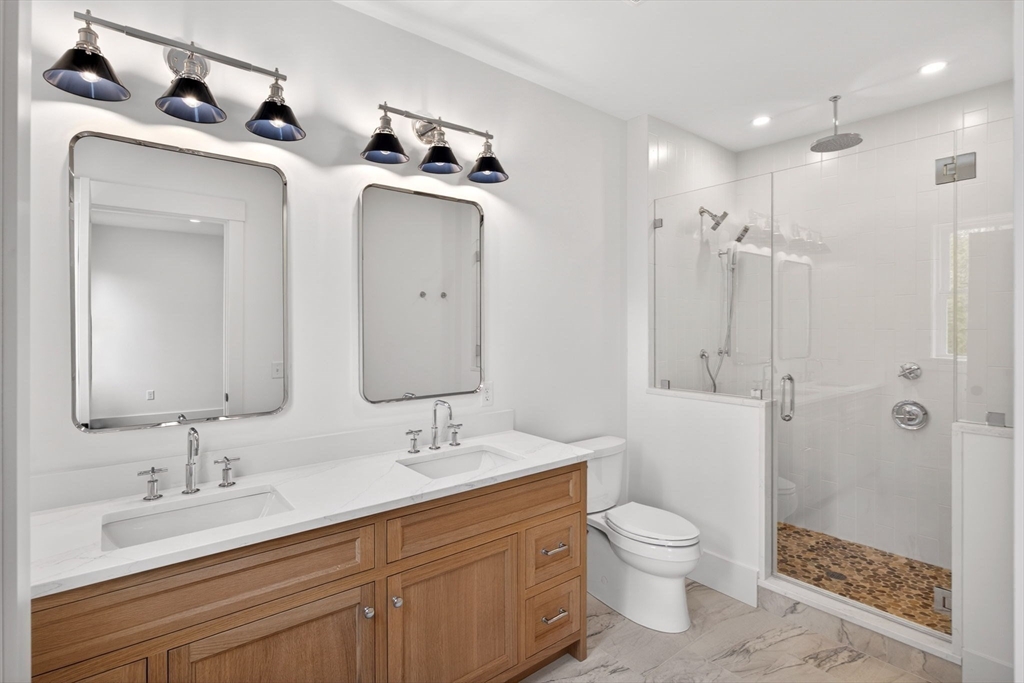 132 Great Western Road Harwich, MA 02645 - Photo 11 of 42 a bathroom with a toilet sink double vanity and mirror