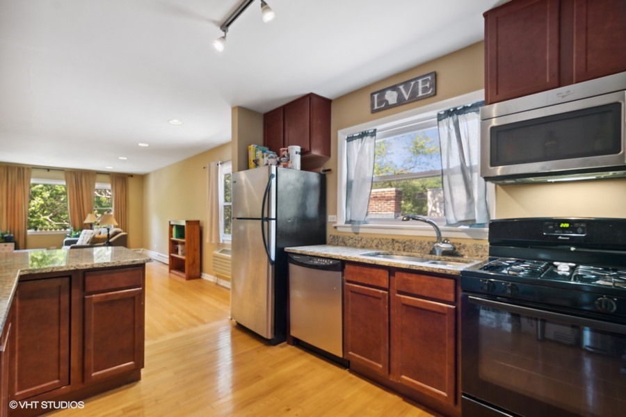 2145 Ridge Avenue, Unit 3A Evanston, IL 60201 - Photo 6 of 11 a kitchen with stainless steel appliances granite countertop a stove refrigerator sink and cabinets