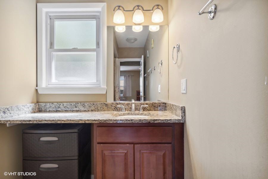 2145 Ridge Avenue, Unit 3A Evanston, IL 60201 - Photo 9 of 11 a bathroom with a sink and a mirror