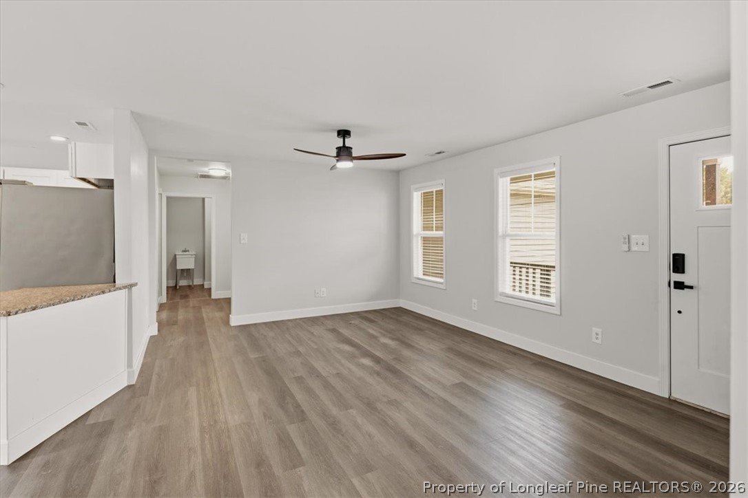 170 Starlight Road Lillington, NC 27546 - Photo 9 of 37 a view of an empty room with a window and wooden floor