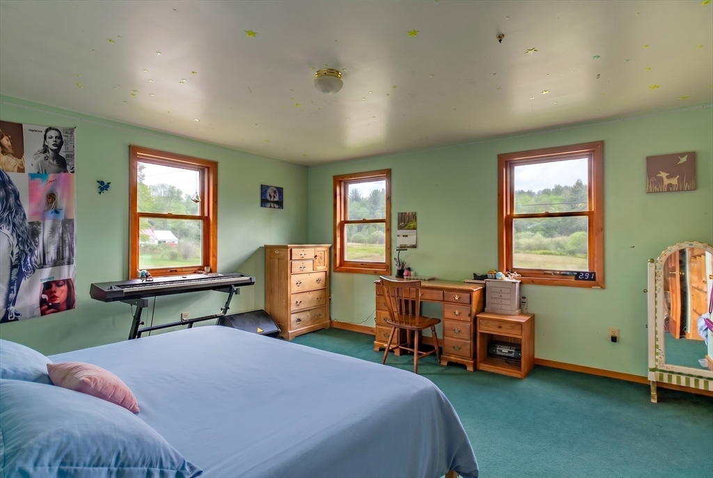 425 Dingle Road Worthington, MA 01098 - Photo 16 of 32 a spacious bedroom with a bed and a window