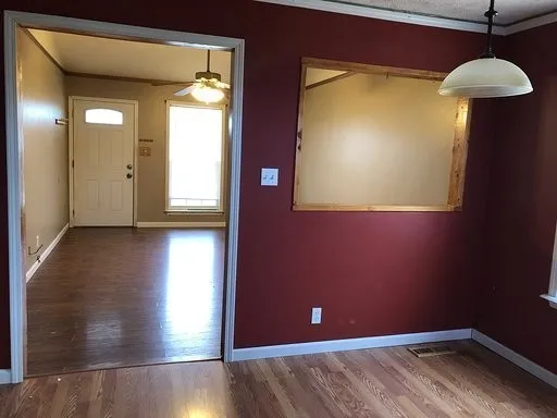 a view of a room with wooden floor and a cabinet