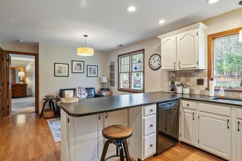83 Thayer Road Monson, MA 01057 - Photo 12 of 42 a kitchen with a table chairs sink and cabinets